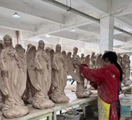The workers are dressed in workwear, holding spray guns and brushes